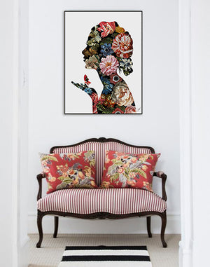 Floral Reflection II, a print by Jackie Von Tobel with a woman in profile rendered in floral blossoms in red, pink, blue, and white, hanging above a pretty settee.